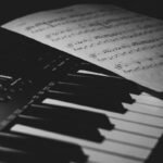 a piano keyboard with sheet music on it